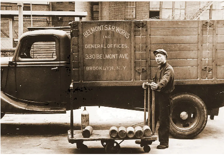 Black-and-white archival photo of a Belmont Smelting & Refining Works delivery truck parked on a Brooklyn street in the early 20th century